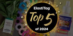 "ElastiTag Top 5 of 2024" in gold on black circle. Basil, tags, and fragrance bottle around it.
