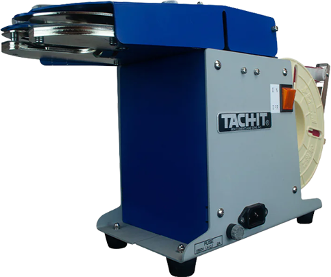 Tach‑It tabletop twist tying machine with blue housing and metal components, designed for entry-level automation in bag closing and product bundling applications.