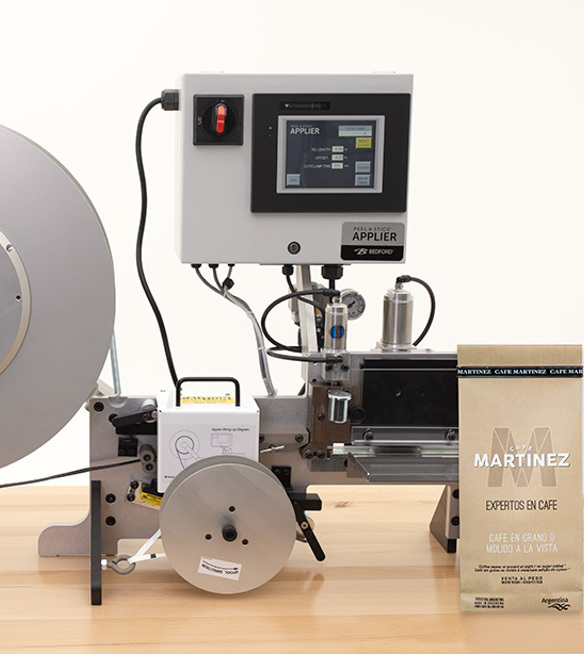 Machine that applies Peel and Stick bag closures horizontally.
