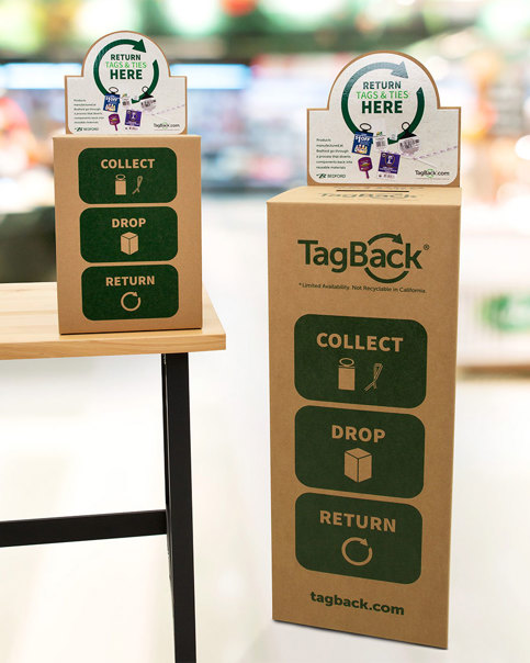 Two TagBack collection boxes, one mini on a table, and one standard taller one on the floor.