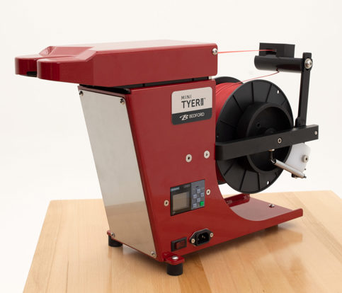 Red Mini Tyer Pro twist tying machine with spool of red twist tie ready to apply.