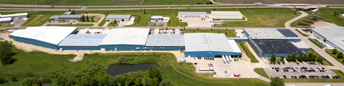 Aerial view of Bedford buidling, which has blue siding and is many buildings long.