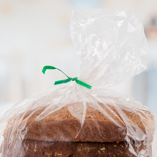A bread bag with green twist tie highly focused.