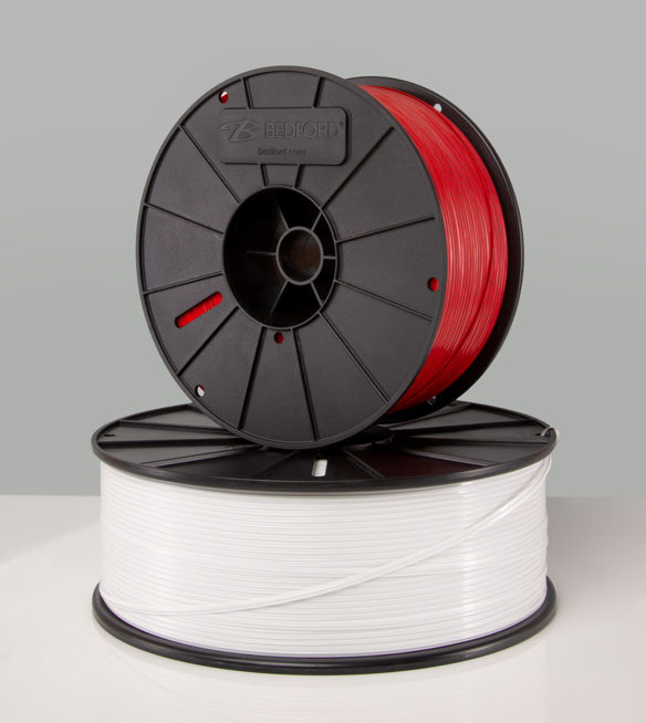 Two spools of twist ties, one red and one white, stacked on top of the other with "Bedford.com" logo on the red spool.