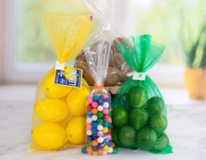 Plastic clip bag closures secure bags of lemons, limes, potatoes, and colorful hard candy.