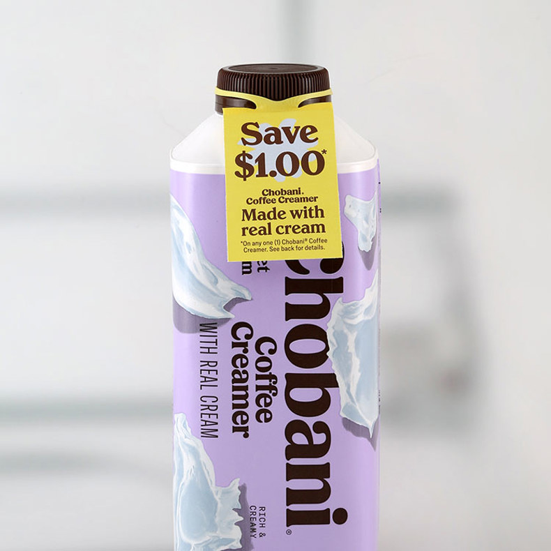 A yellow Save $1 coupon ElastiTag with yellow elastomer on a bottle of Chonbani Coffee Creamer