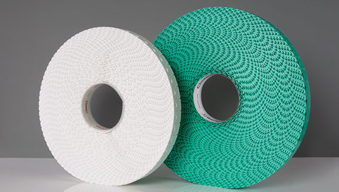 Two spools of CloseIt bag closures side by side, one white, and one larger green. 