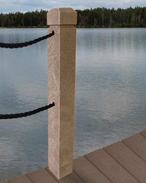 Tan bollard on a wooden dock with black ropes, overlooking a calm lake and forested shoreline.