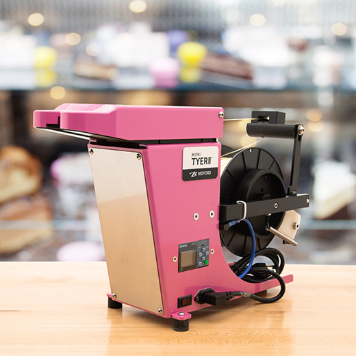 Pink twist tying machine in a candy store. 