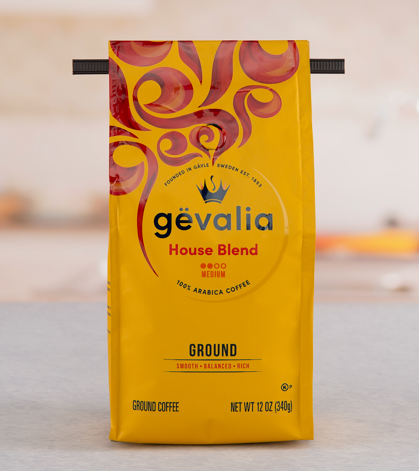 A yellow Gevalia brand coffee bag with tin tie closure