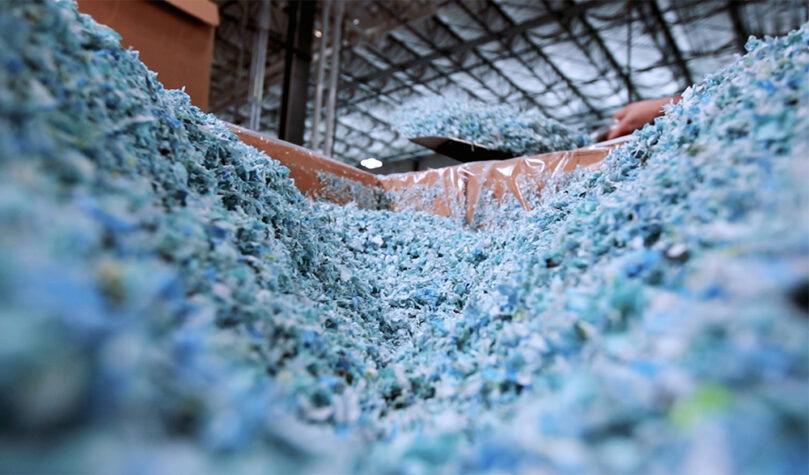 A mass of blue and white plastic that has been ground up to be recycled.