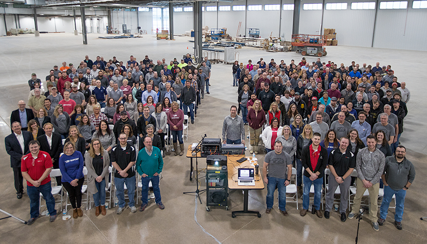 Bedford Employee Family A large group of Bedford Employees pose for a photo in a newly built addition to our manufacturing facility