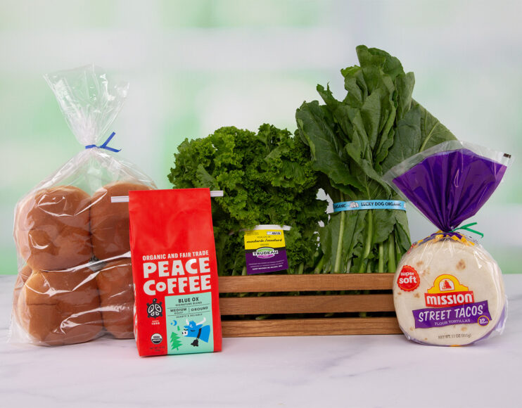 A coffee bag with tin tie, bread buns & tortilla shells with twist tie, and leafy greens with identification tags.