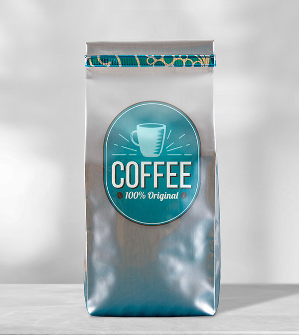 Silver coffee bag with teal and silver patterned tin tie on coffee bag.