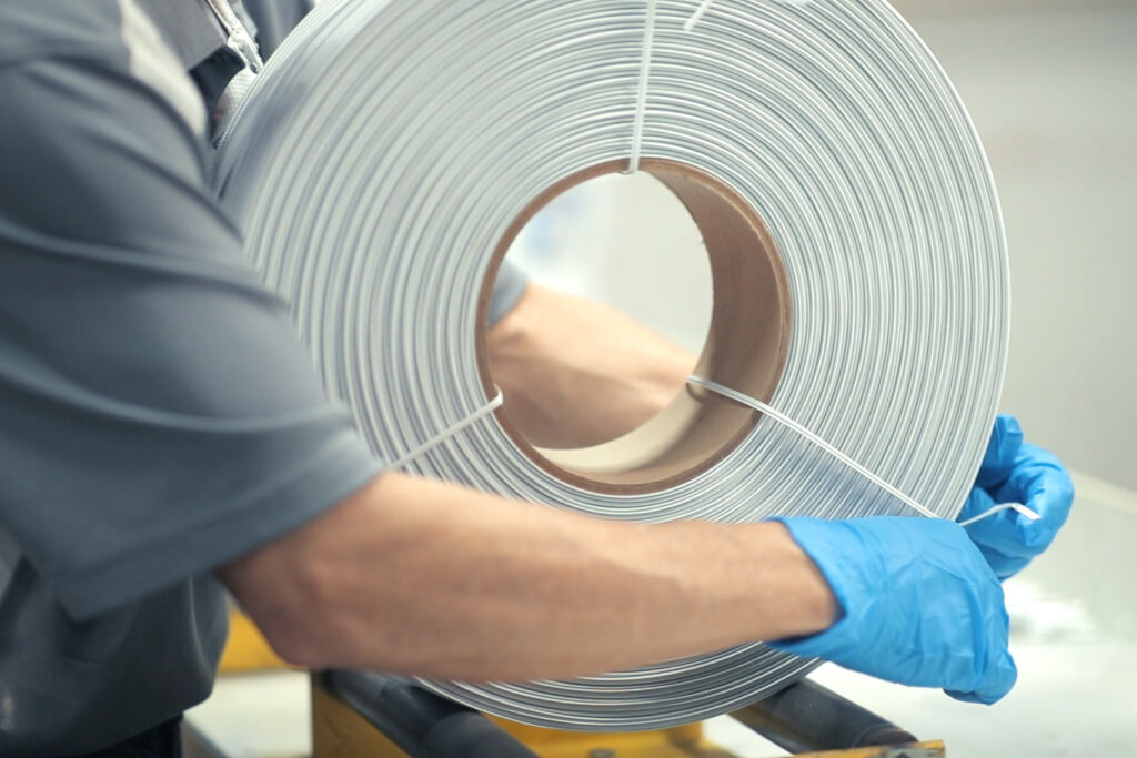 worker tying up a spool