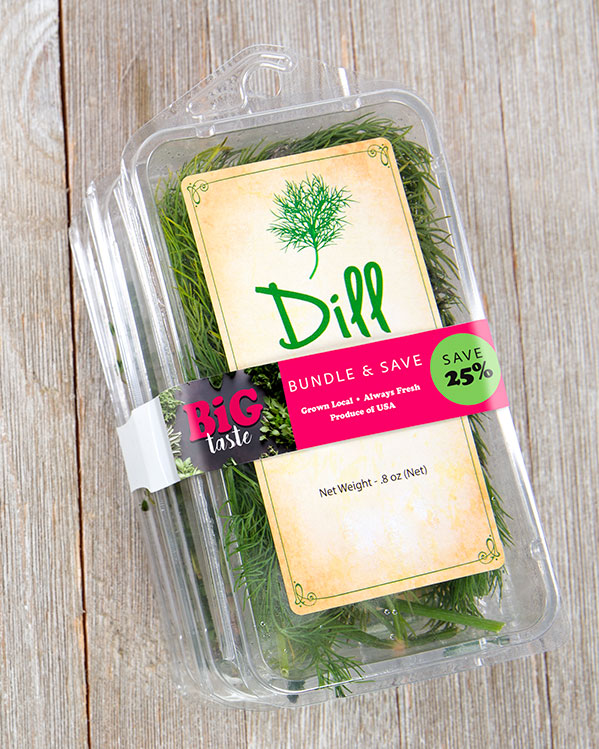 EBandPromo_Clamshell_BigTaste3 A clear plastic container of fresh dill with a second container being held to it with a bright pink ElastiTag band.
