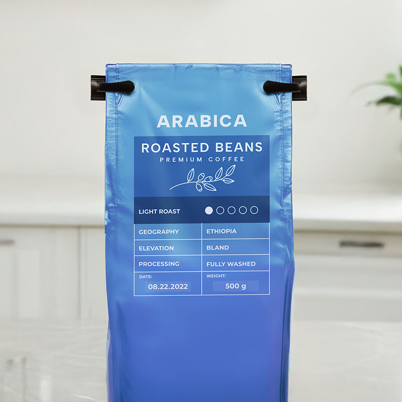 A shiny blue coffee bag closed with a PE coffee closure.